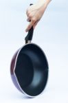 Hand With Non Stick Frying Pan On White Background Stock Photo