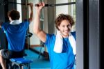 Caucasian Man Sitting On Bench And Exercising Stock Photo