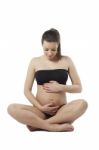 Woman Holding Her Pregnant Belly. White Background Stock Photo