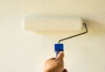 Hand Painting Wall With Paint Roller Stock Photo