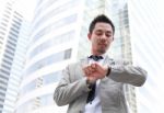 Young Businessman Looking At His Wristwatch Stock Photo