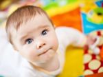 Infant Boy On Playmat Stock Photo