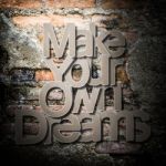 Meaningful Word On Old Brick Wall Background Stock Photo