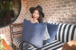 Woman Smiling Near Rustic Brick Wall Stock Photo