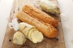 Baguette With Herb Butter And Rosemary Thyme On Rustic Wooden Background Stock Photo