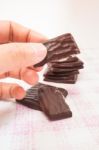 Hand On Peppermint Chocolate Piece Stock Photo