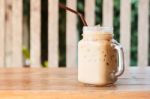 Glass Of Iced Coffee On Wooden Table With Vintage Filter Style Stock Photo