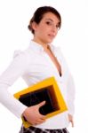 Side View Of Female Student Holding Books Stock Photo