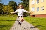 Little Girl Jumping Rope Outside Stock Photo