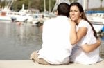 Couple Seated At Footbridge Stock Photo