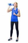 Woman In Fitness Clothing Drinking Stock Photo