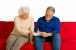 Elderly Couple Writing Stock Photo