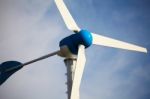 Green Renewable Energy Concept - Wind Generator Turbines On Blue Stock Photo