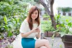 Portrait Of Thai Student University Beautiful Girl Using Her Smart Phone Stock Photo