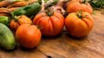 Several Vegetables On Wooden Chopping Board And Table Stock Photo