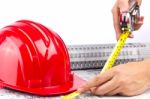 Measuring Hand With Hard Hat Stock Photo