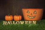 Wooden Halloween Words And Pumpkin On Grass Background Stock Photo