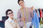 Two Young Businesswomen Working With Digital Tablet In Her Offic Stock Photo