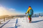 Young Woman Hiking With A Backpack On Mountains In Winter Stock Photo