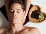 Young Man Getting Face Massage Stock Photo