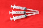 Three Hypodermic Syringe On Red Velvet For First Aid Kids Stock Photo