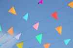 Multiple Line Of Celebration Flags On Blue Sky Stock Photo