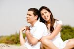 Love Couple Sitting Together Outside Stock Photo