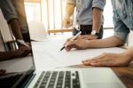 Architects Engineer Discussing At The Table With Blueprint - Clo Stock Photo