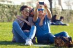 Group Of Students Taking Photos With A Smartphone In The Street Stock Photo