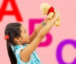 Girl Holding Teddy Bear Stock Photo