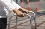 Senior Woman Using A Walker Cross Street Stock Photo