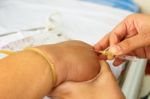 Asian Nurse Inject At Patient's Hand For Intraveneous Fluid Stock Photo