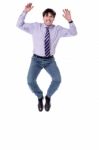 Excited Businessman Jumping High Stock Photo