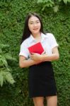 Thai Adult Student University Beautiful Girl Reading Red Book Stock Photo