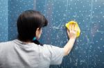 Woman Washes Tile With A Cloth Stock Photo