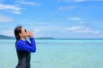 Asian Woman Shouting With Hands On The Sea In Summer, Thailand Stock Photo