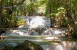 The Water Flowing Over Rocks And Trees Down A Waterfall At Huay Mae Khamin Waterfall National Park ,kanchana Buri In Thailand Stock Photo