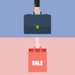 Male Hand Holding Briefcase And Female Hold Shopping Bag Stock Photo