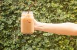 Hand Hold Glass Of Iced Coffee With Vintage Filter Effect Stock Photo