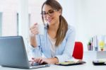 Pretty Young Woman Using Her Laptop In The Office Stock Photo