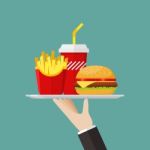 Waiter Serving A Hamburger French Fries And Soda Stock Photo