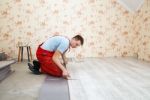 Handyman Laying Down Laminate Flooring Boards Stock Photo