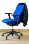 Modern Blue Office Chair With Jacket On Back Stock Photo