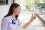 Portrait Of Thai Student Teen Beautiful Girl Using Her Phone And Smile Stock Photo