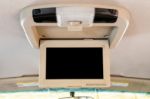 Interior Detail Of Modern Luxury Car Dashboard With Big Display And Light Button Switch On Ceiling. Screen Multimedia System Stock Photo