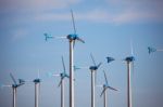 Green Renewable Energy Concept - Wind Generator Turbines On Blue Stock Photo