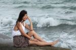 Girl Sitting Near The Sea Stock Photo