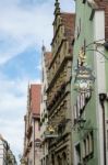 Various Hanging Signs In Rothenburg Stock Photo