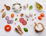 The Ingredients For Homemade Pizza On White Wooden Background Stock Photo