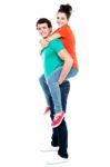 Male Giving Piggyback Ride Stock Photo